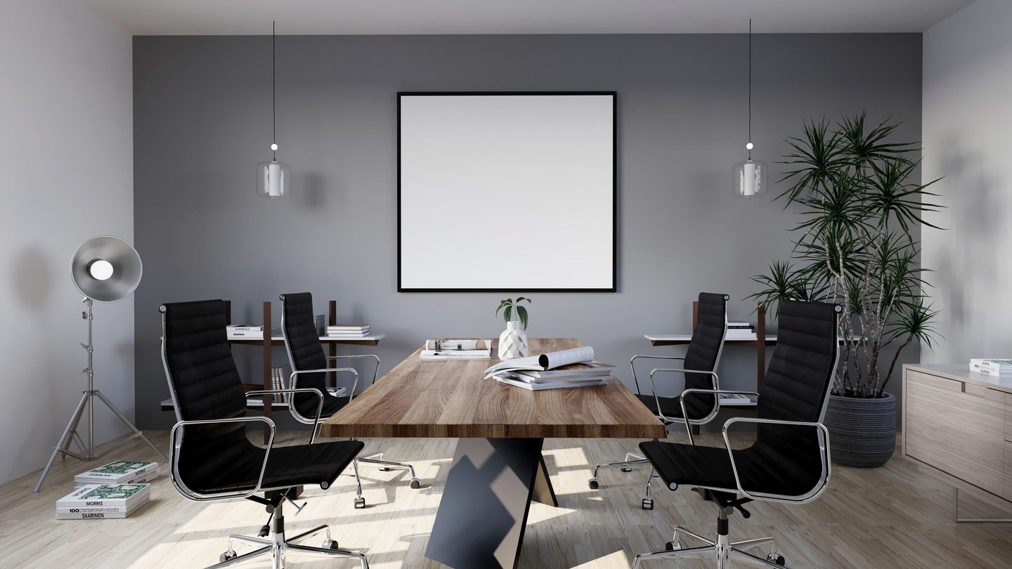 An empty boardroom with a long table, chairs and soft daylight